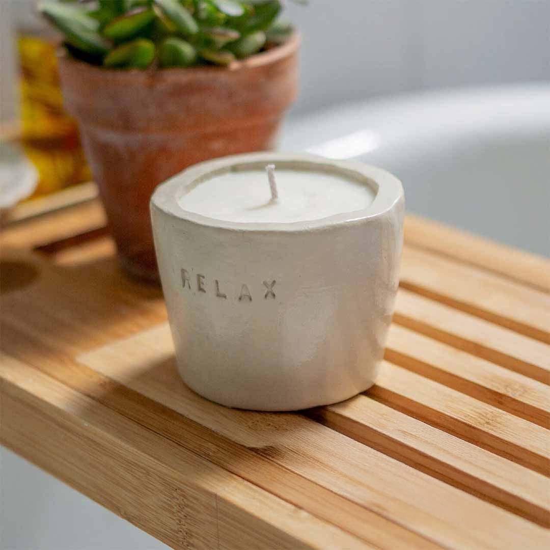 Sculpd Candle Pot unpainted and stamped with the word Relax using Sculpd Clay Letter Stamps