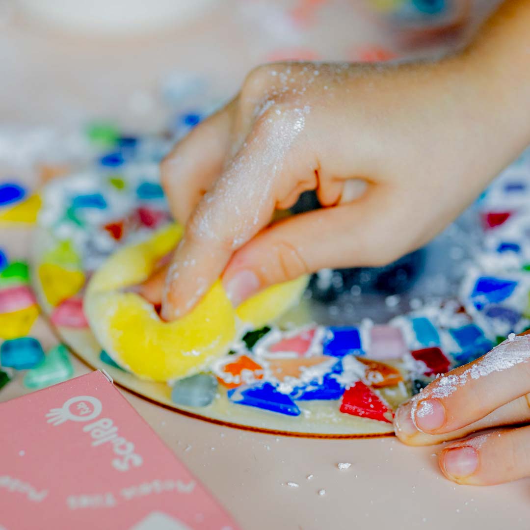 A half-finished Sculpd Kids Mosaic Kit Mirror being sponged on with Premium Mosaic Powder