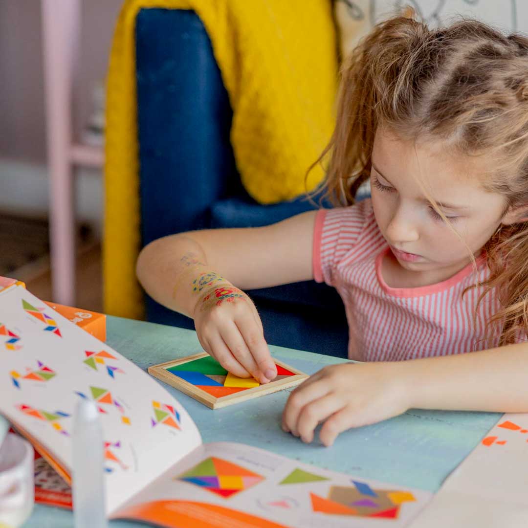 Girl playing with a Sculpd Kids Mosaic Kit Tangram Tile Game