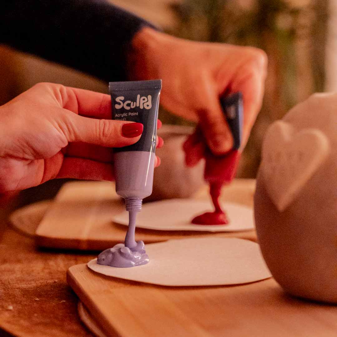 Sculpd Paint Set being poured onto cardboard paint palette
