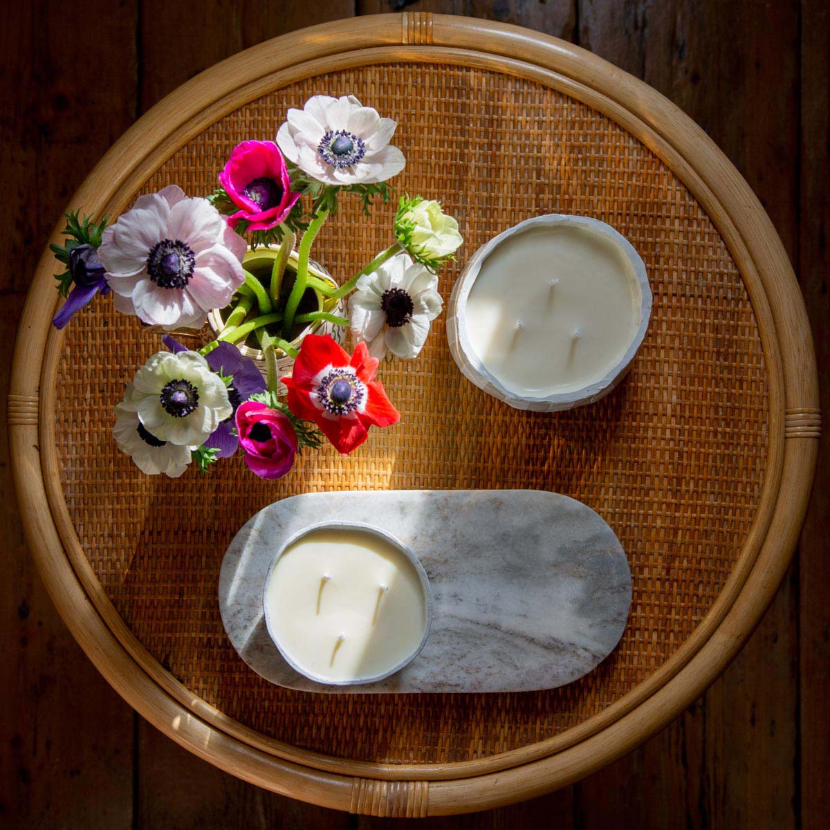 Sculpd Candle Making Kit pots laid out on a table with flowers