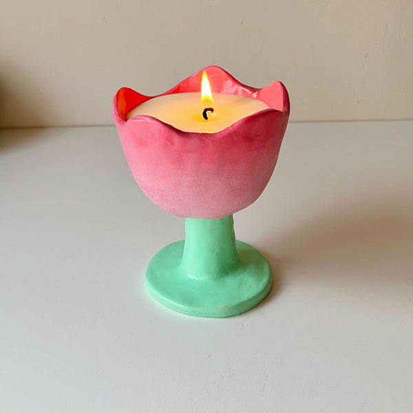 Candle in a pink and green tulip-shaped pottery creation
