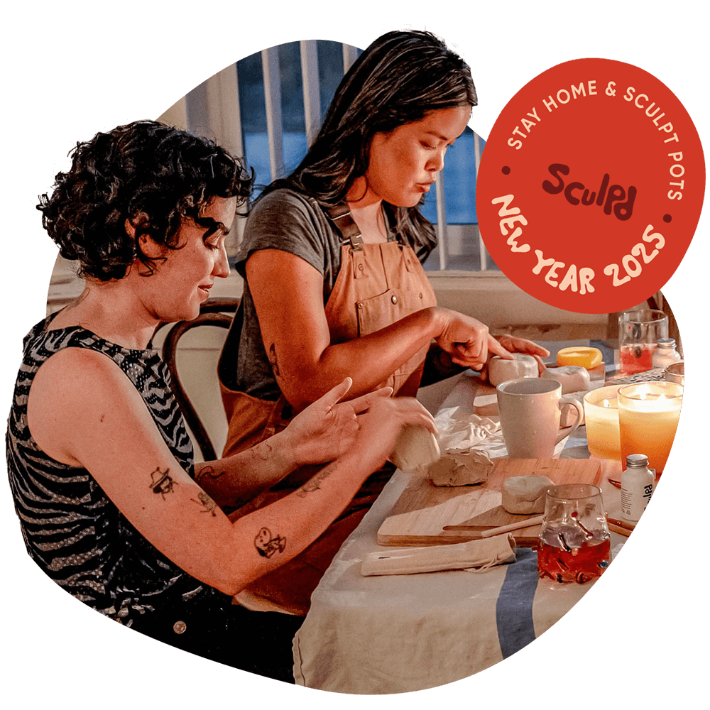 Two women hand-shaping clay Sculpd Pottery Making Kit pots on a stylized table