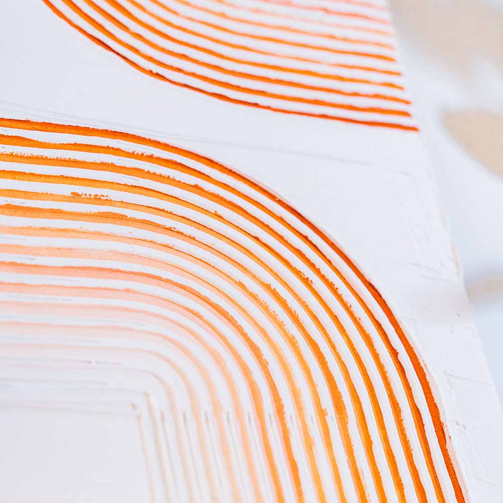 A textured, abstract artwork with curved orange lines made using a Sculpd Textured Canvas Kit
