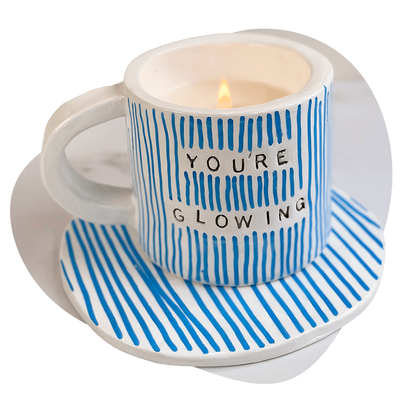 Sculpd Candle Making Kit Candle pot with a lit wick stamped with the words You're Glowing